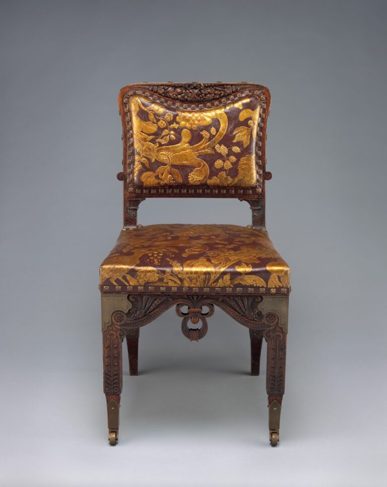 Side chair in oak with brass and embossed leather upholstery