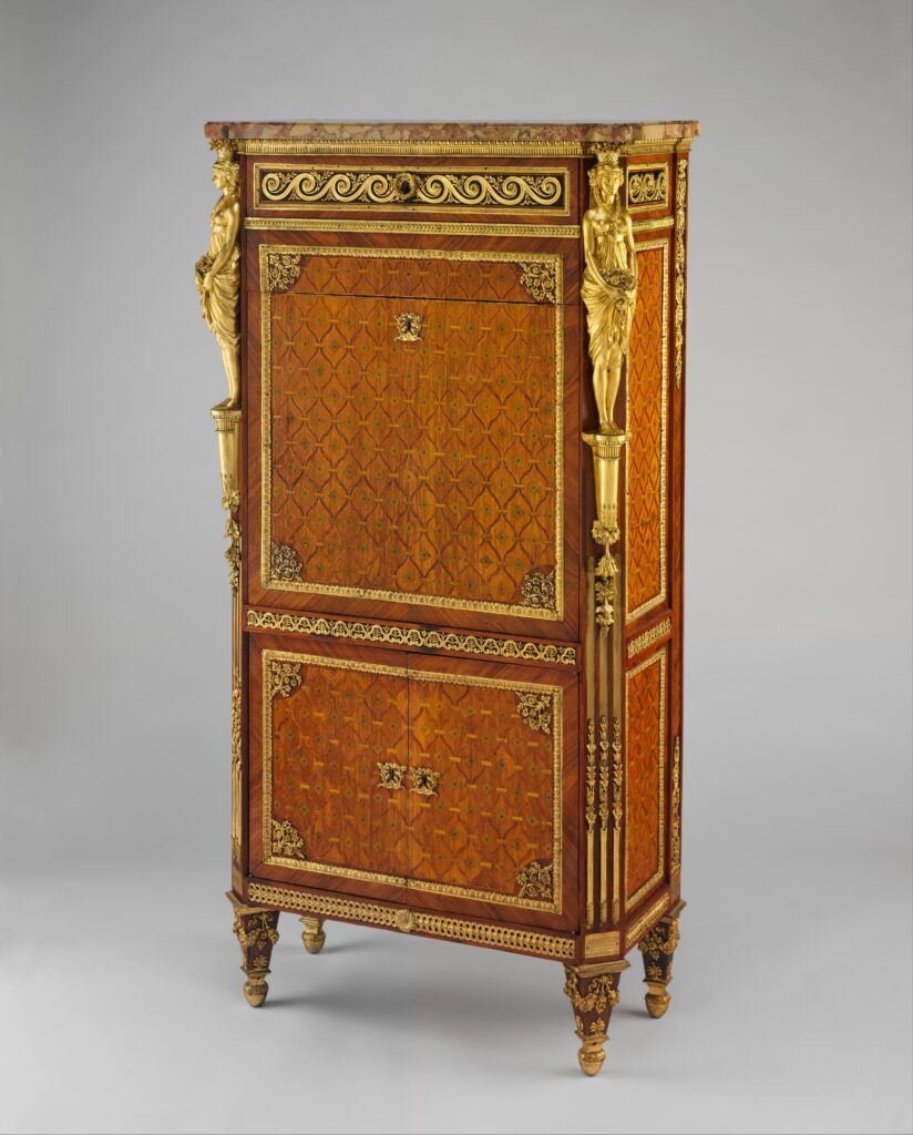 Tall secretary with a geometric marquetry front in warm orange and brown woods, gilt-bronze caryatid mounts at the corners and a pattern band across the top