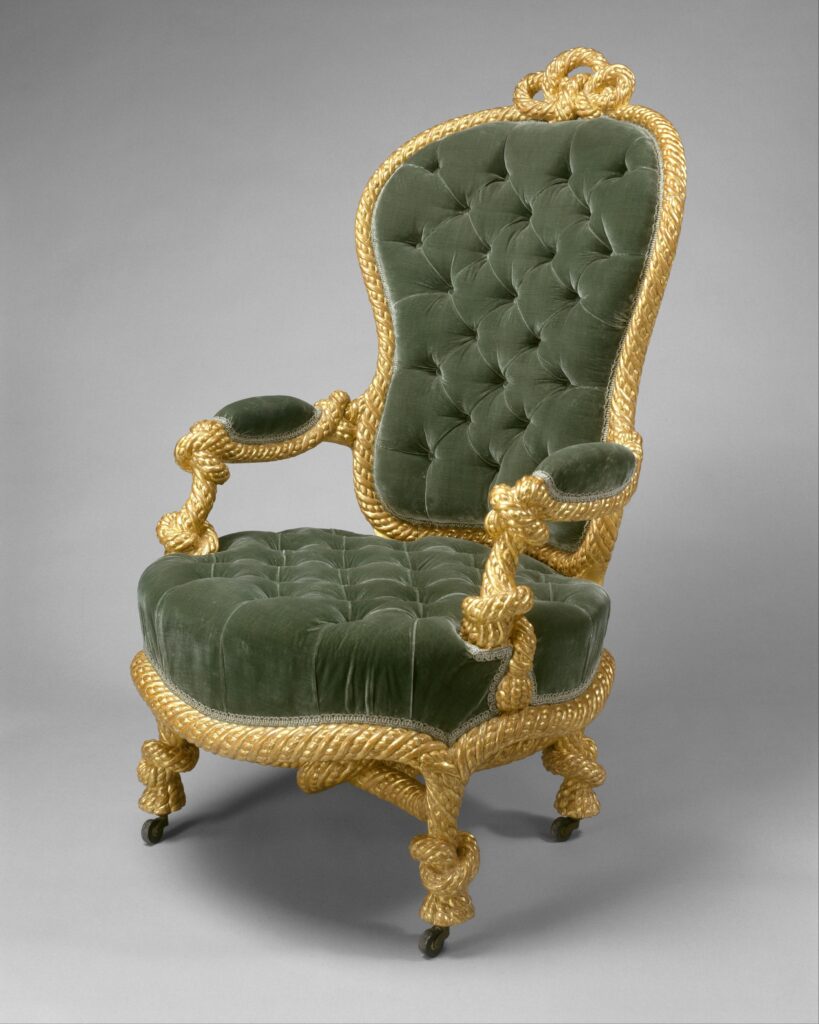 Gilded armchair with a deeply buttoned green velvet back and seat and arms carved as twisted rope, on a grey ground