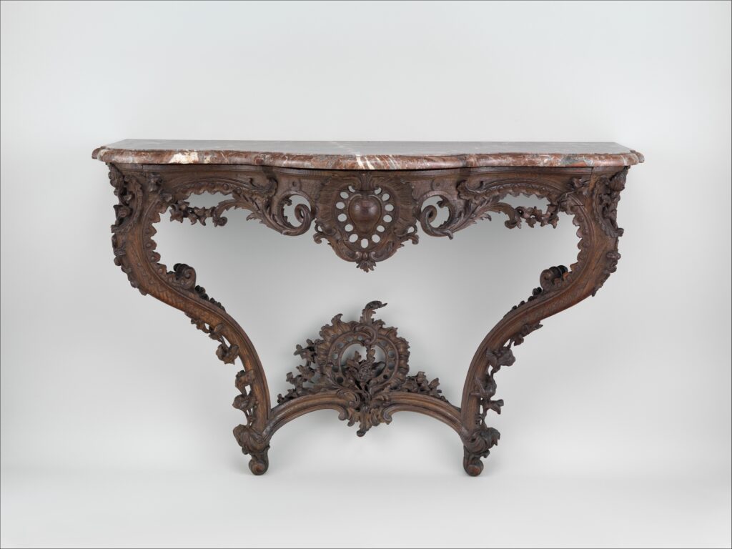 Carved wooden console table with a marble top, curving legs, an openwork shell-like cartouche and a curved stretcher