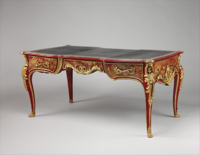 Antique French writing desk of crimson lacquer painted with gold landscapes, with curving legs, scrolling gilt-bronze mounts and a flat dark leather-lined top
