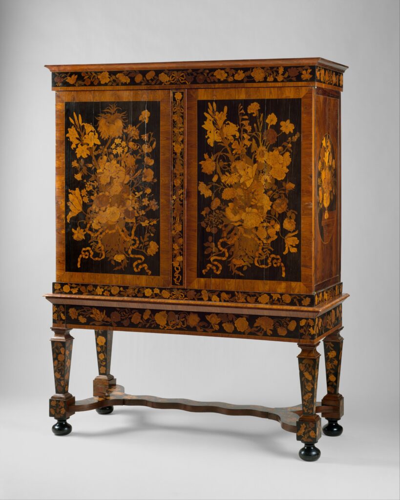 Tall Dutch cabinet on a stand, its two doors covered in marquetry bouquets of flowers in many colored woods against a dark ground
