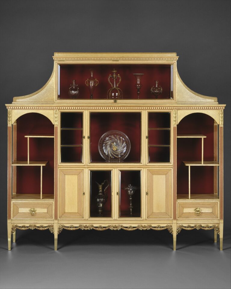 Ivory-and-gold Herter Brothers cabinet of about 1883, an antique display cabinet with a glazed center, a glazed compartment above and open shelves at each end, the interiors lined in deep red and set with small vessels