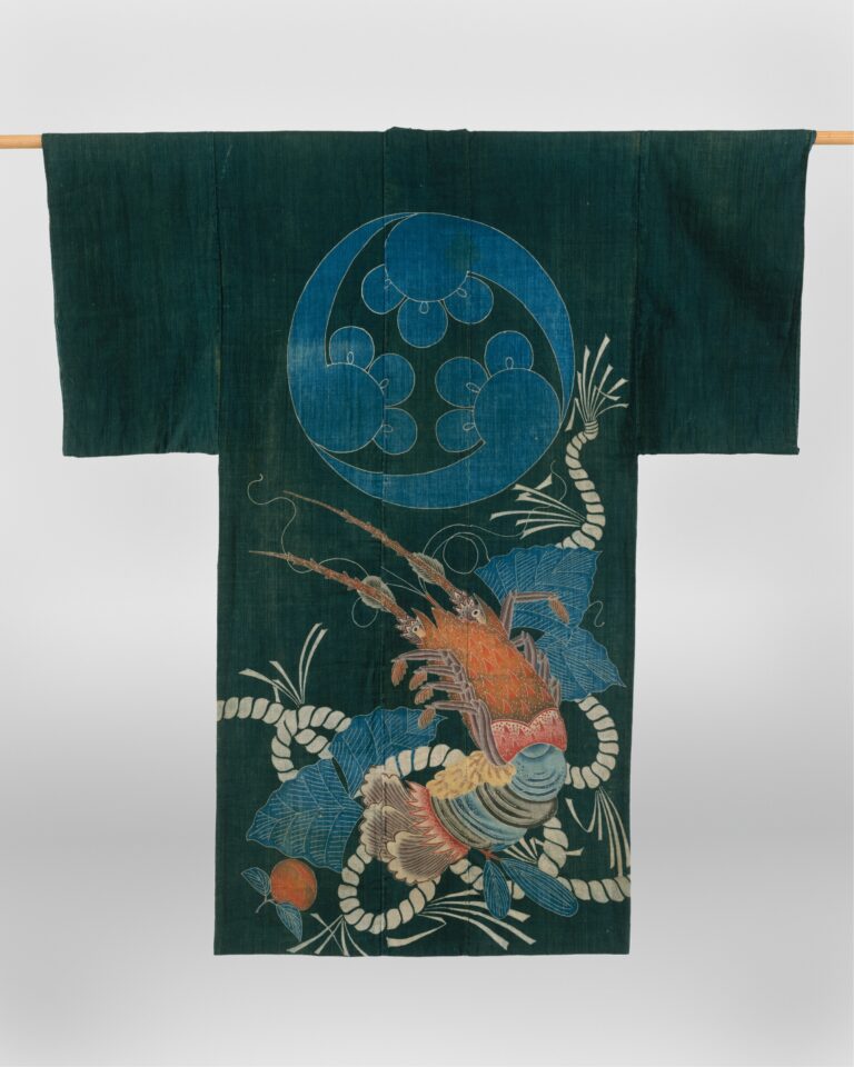 Dark indigo kimono-shaped coverlet with long sleeves, a large pale-blue round crest at the chest and a painted spiny lobster tangled in rope below