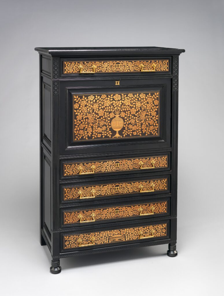 Black fall-front secretary with a drawer base, its drawer fronts and writing flap covered in gold marquetry of flowers and a central vase