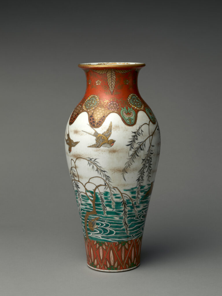 Tall vase with an orange-red neck and base and a white body painted with birds and willow, with gold details