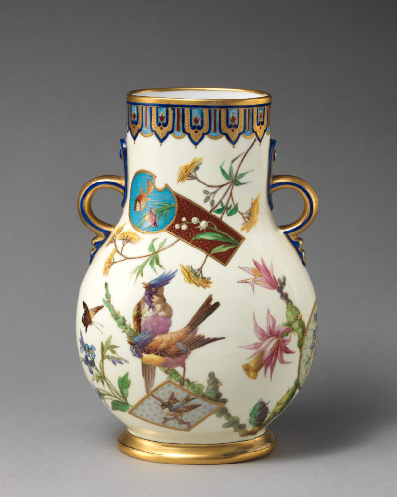 Minton japonisme vase in cream bone china, with two gilt handles and a gold rim, painted with a bird on a flowering stem and pink and yellow blossoms