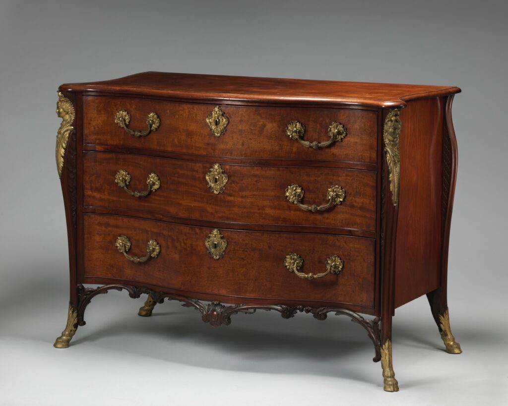 English chest of drawers by William Vile, about 1750, with a serpentine mahogany front, three drawers, gilt-bronze corner mounts and a carved apron