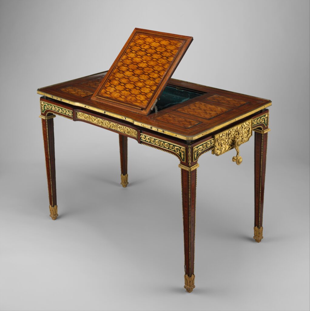 Rectangular marquetry table on slender tapering legs with gilt-bronze mounts and a raised central panel tilted up like a reading stand